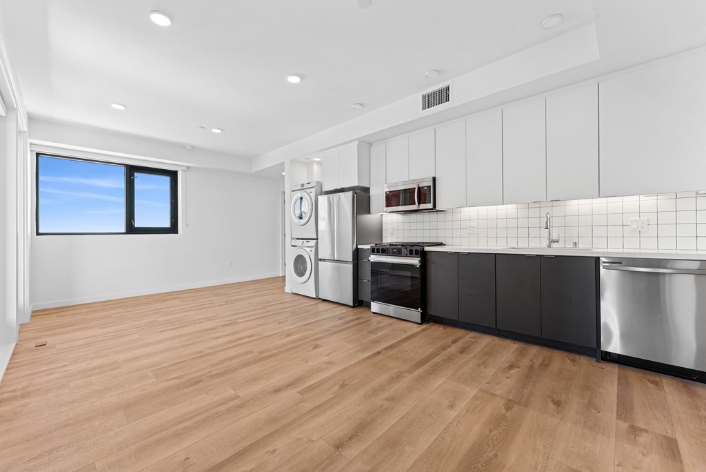 OnyxOnPark_SanDiego_CA_Vacant_2BR_B1_A kitchen with a washer and dryer built in.