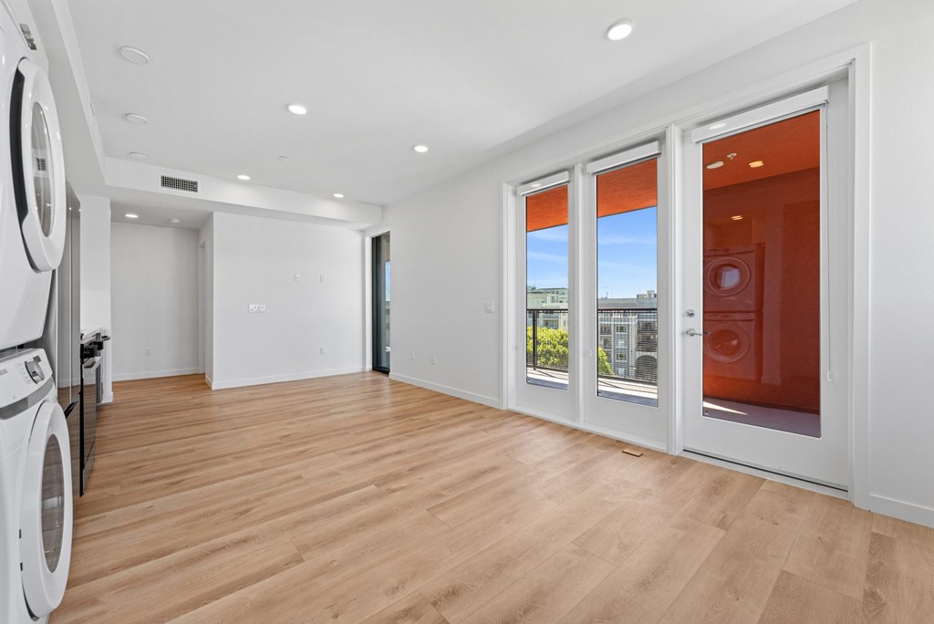 OnyxOnPark_SanDiego_CA_Vacant_2BR_B1_A room with a washing machine and a view of the outside through the window.