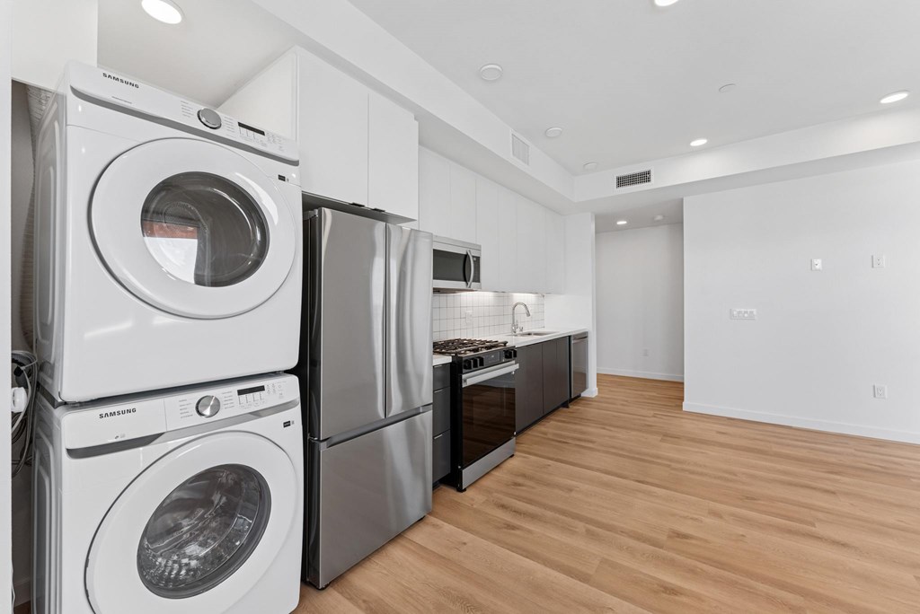 OnyxOnPark_SanDiego_CA_Vacant_2BR_B1_A stack of white washing machines in a laundry room.