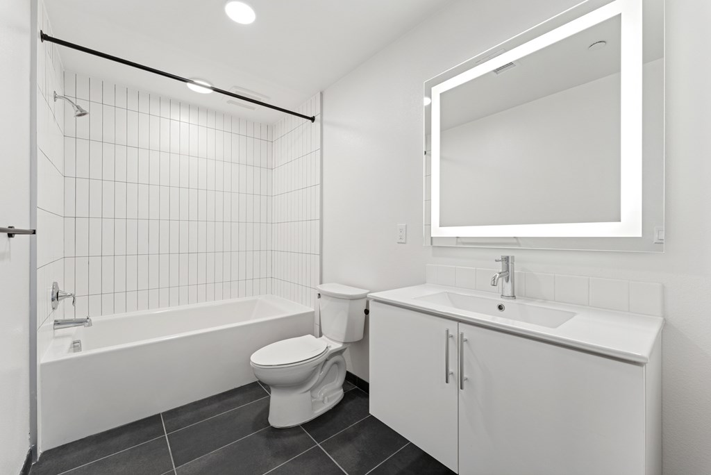 OnyxOnPark_SanDiego_CA_Vacant_2BR_B1_A white bathroom with a toilet, sink, and bathtub.