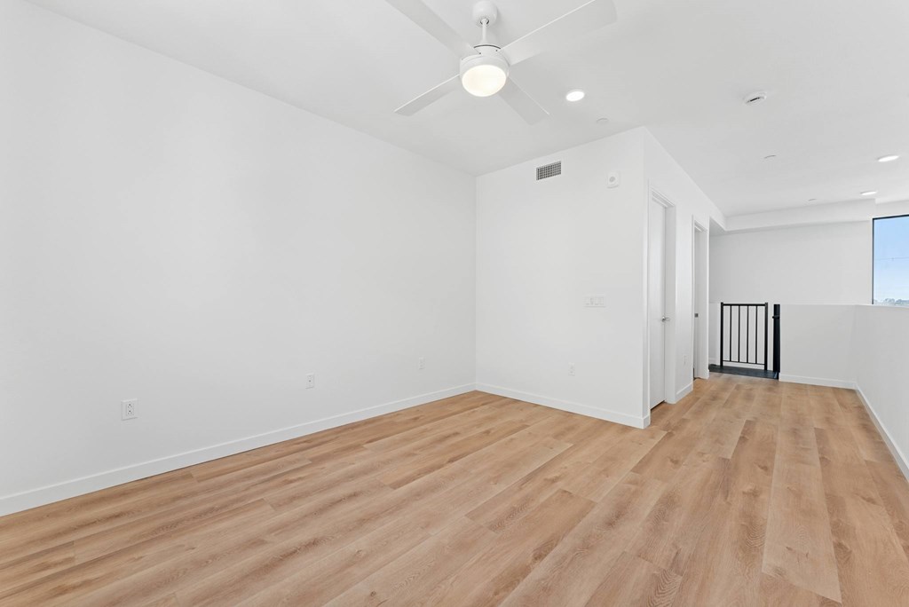 OnyxOnPark_SanDiego_CA_Vacant_Penthouse_A_A room with wooden flooring and white walls.