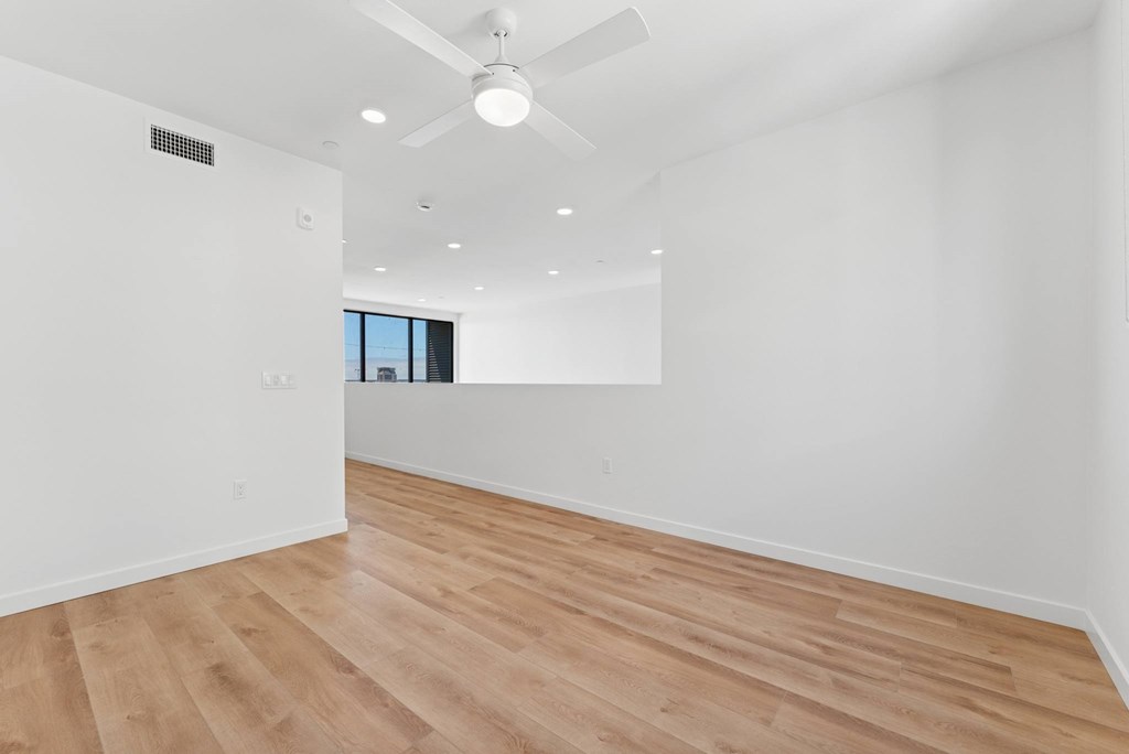 OnyxOnPark_SanDiego_CA_Vacant_Penthouse_A_A room with a ceiling fan and wooden flooring.