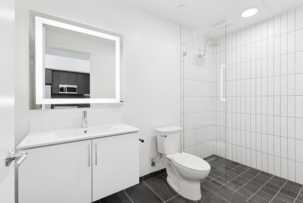 OnyxOnPark_SanDiego_CA_Vacant_Penthouse_A_OnyxOnPark_SanDiego_CA_Vacant_Penthouse_A_A white bathroom with a toilet, sink, and mirror.