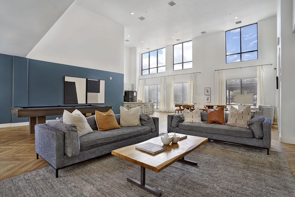 Alvera at the Meadows community lounge with blue sofas and coffee table