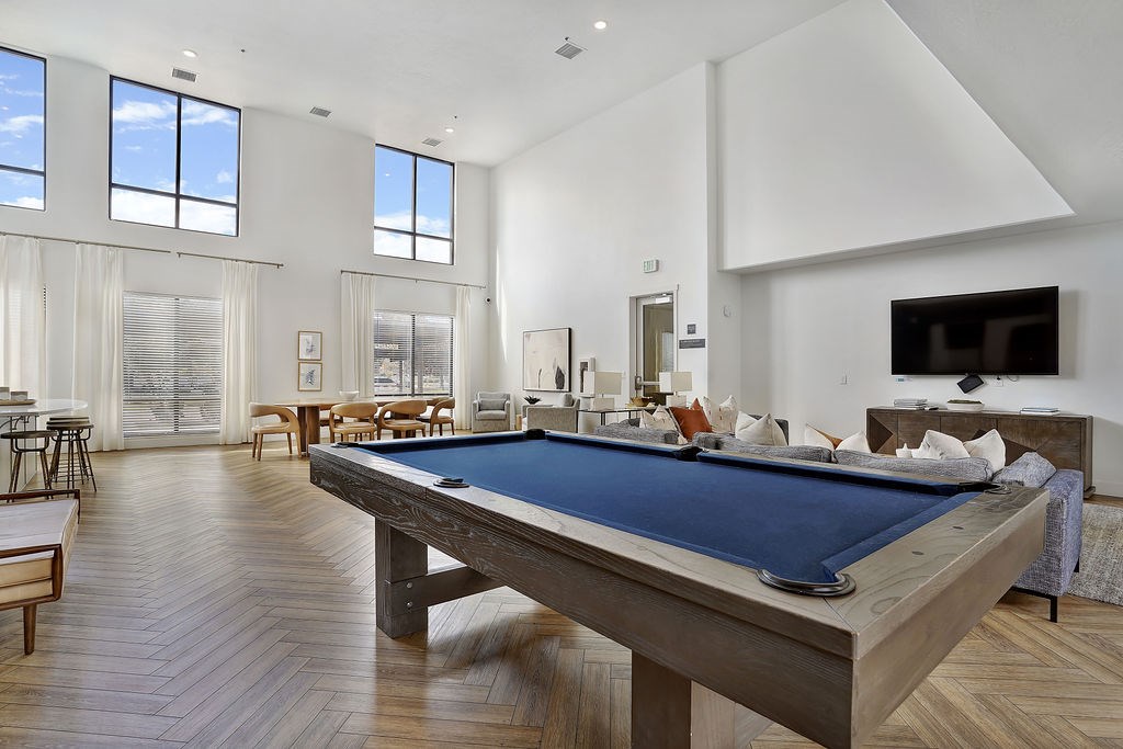 Alvera at the Meadows  A pool table is in the middle of a room with a lot of windows.