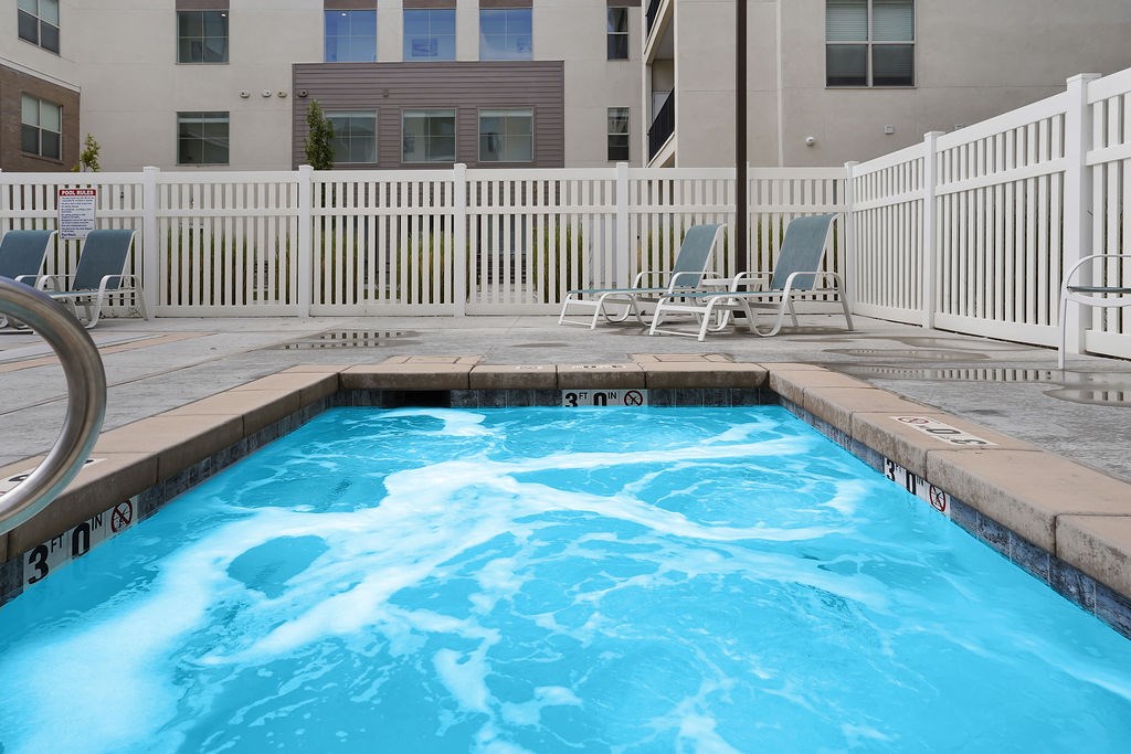 Alvera at the Meadows  spa with a white fence and chairs around it.
