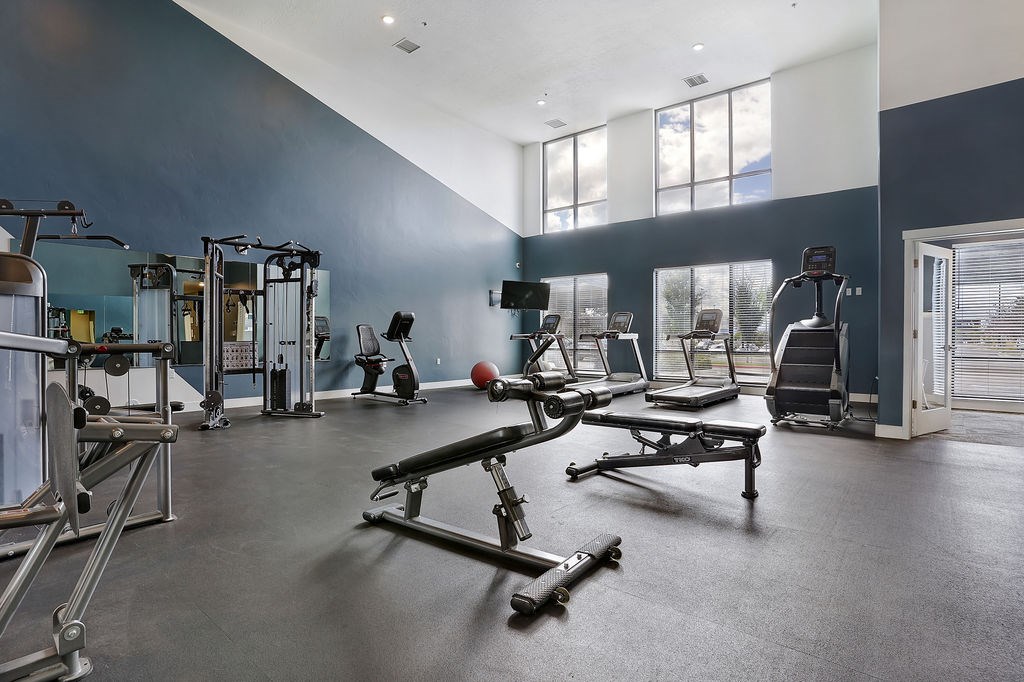 Alvera at the Meadows  gym with a variety of equipment including weights and weight machines.