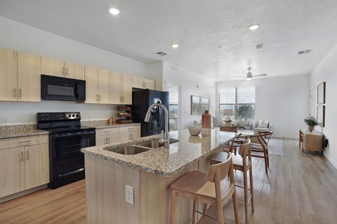 A kitchen with wooden cabinets and a granite countertop.