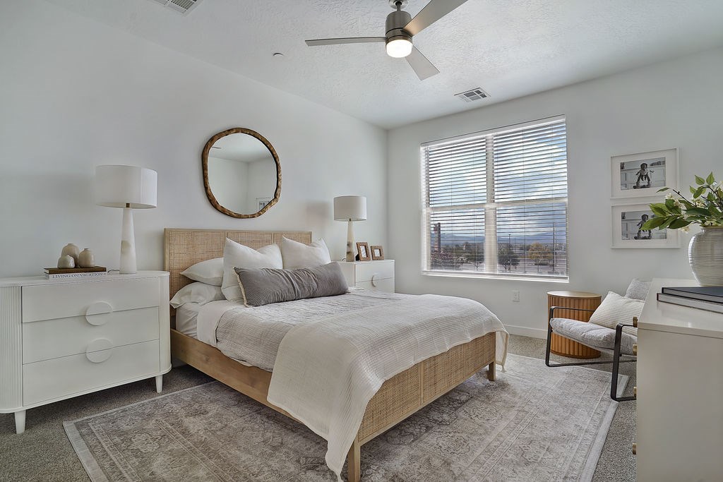 Alvera at the Meadows bedroom with a bed, dresser, and mirror.