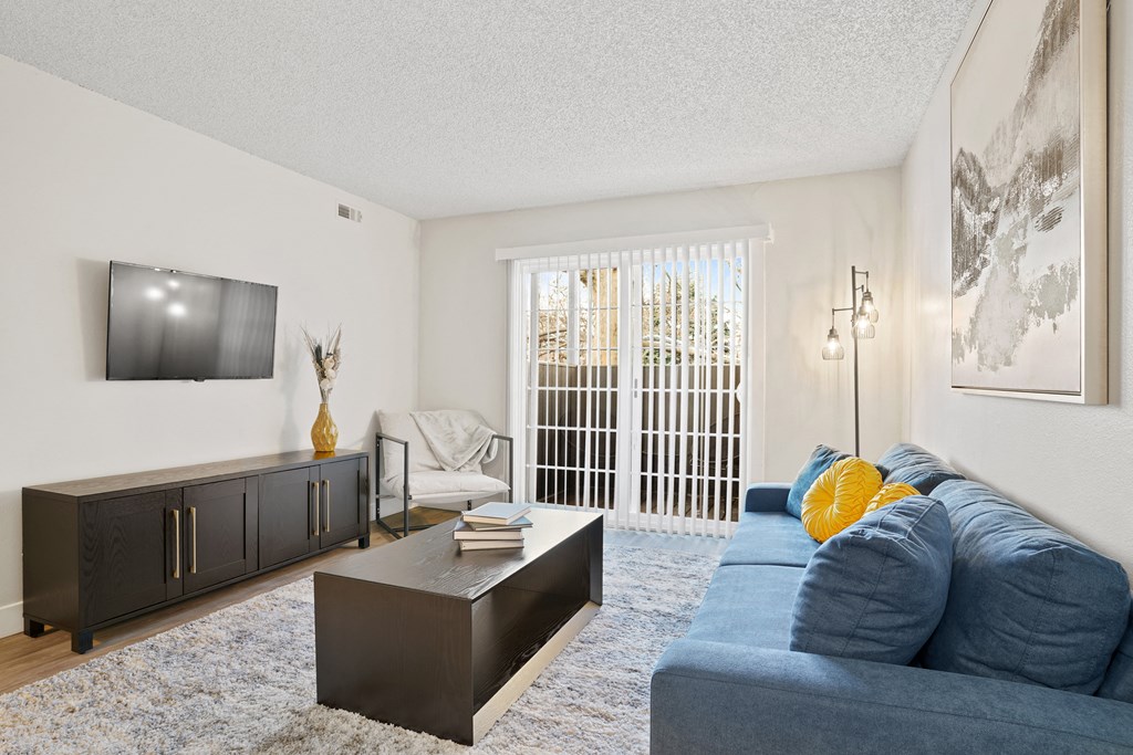 a living room with a blue couch and a tv