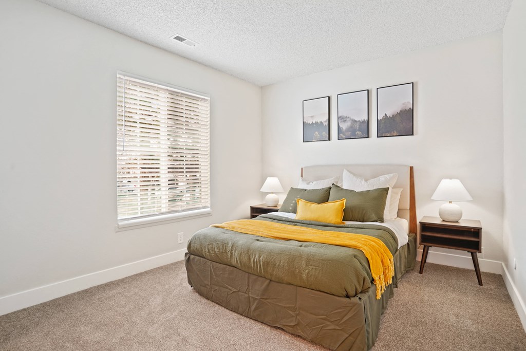 a bedroom with a bed and a window