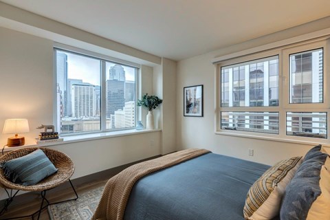 a bedroom with a bed and three windows