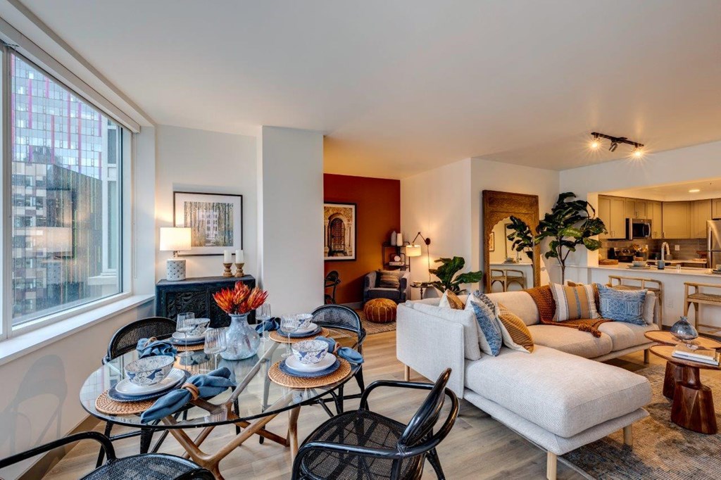 a living room with a glass table and a couch