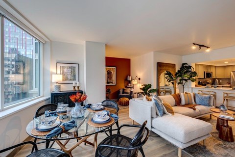 a living room with a glass table and a couch