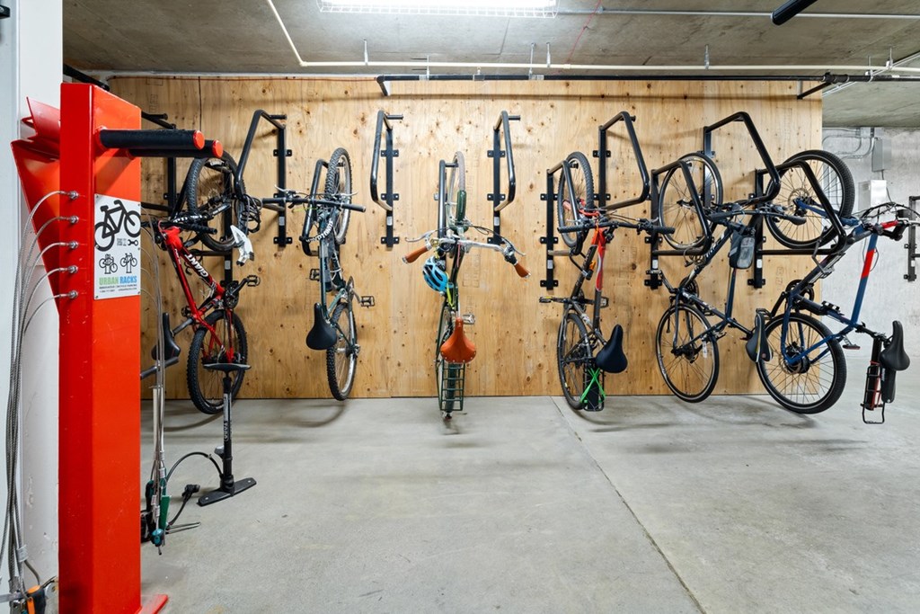 A bike shop with many bikes hanging on the wall.