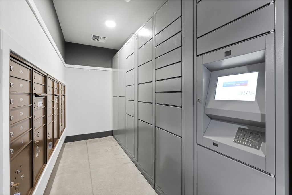 A row of metal safe deposit boxes are lined up against a wall.