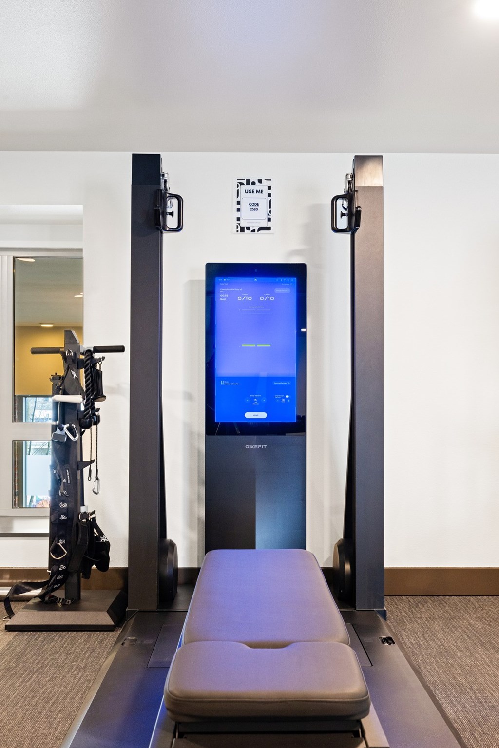 A treadmill with a screen on top of it.