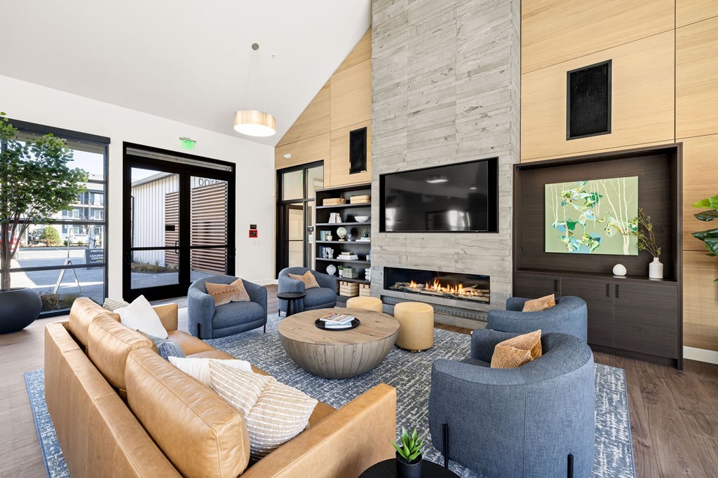 A modern living room with a fireplace and a television.