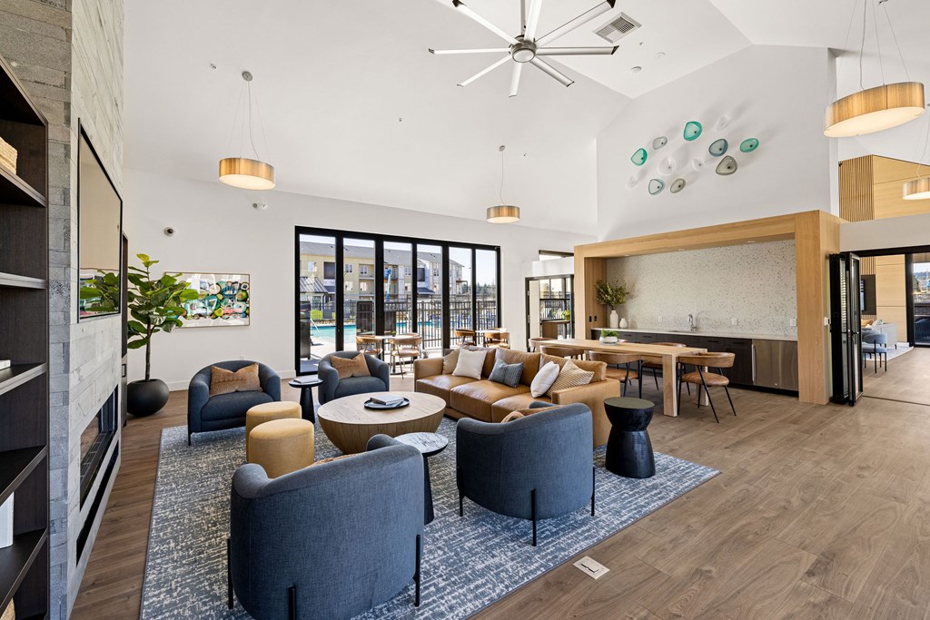 A modern living room with a grey sofa set and a wooden coffee table.