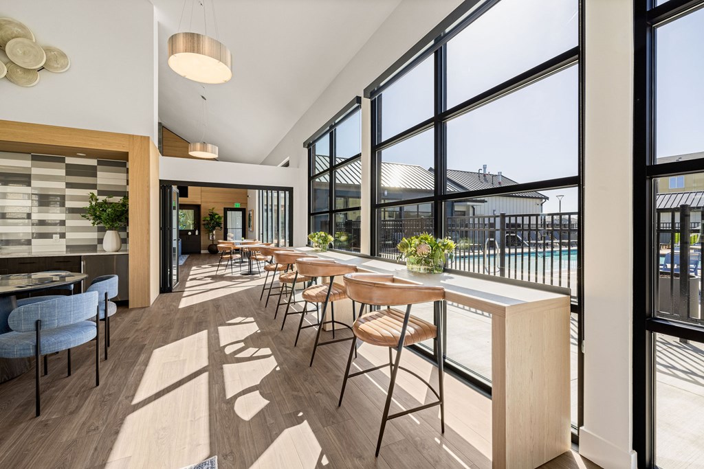 A modern dining room with a long table and chairs.