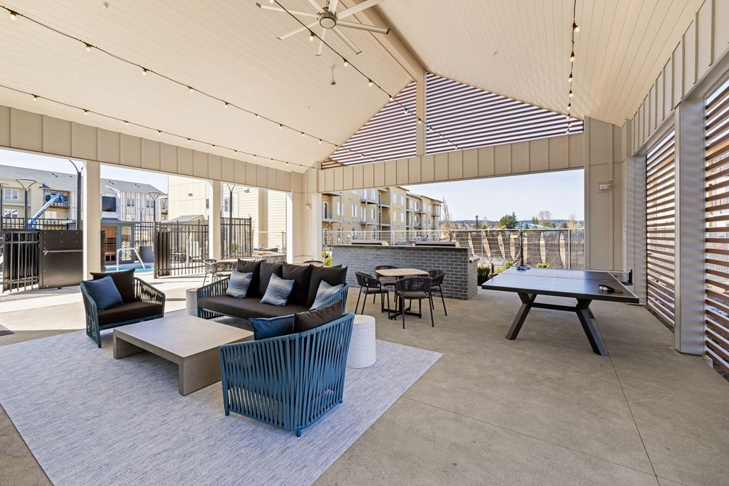 A patio with a table and chairs.