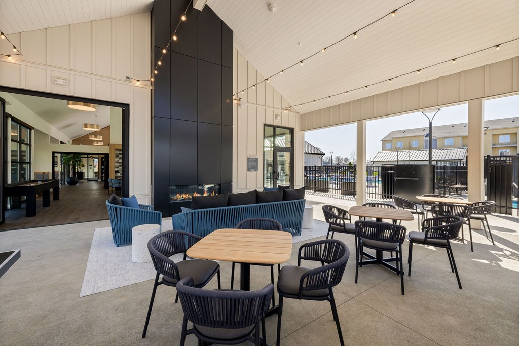 A modern outdoor seating area with tables and chairs.