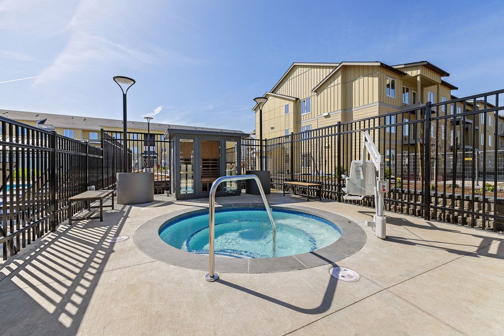 A small pool with a fountain in the middle of a patio.