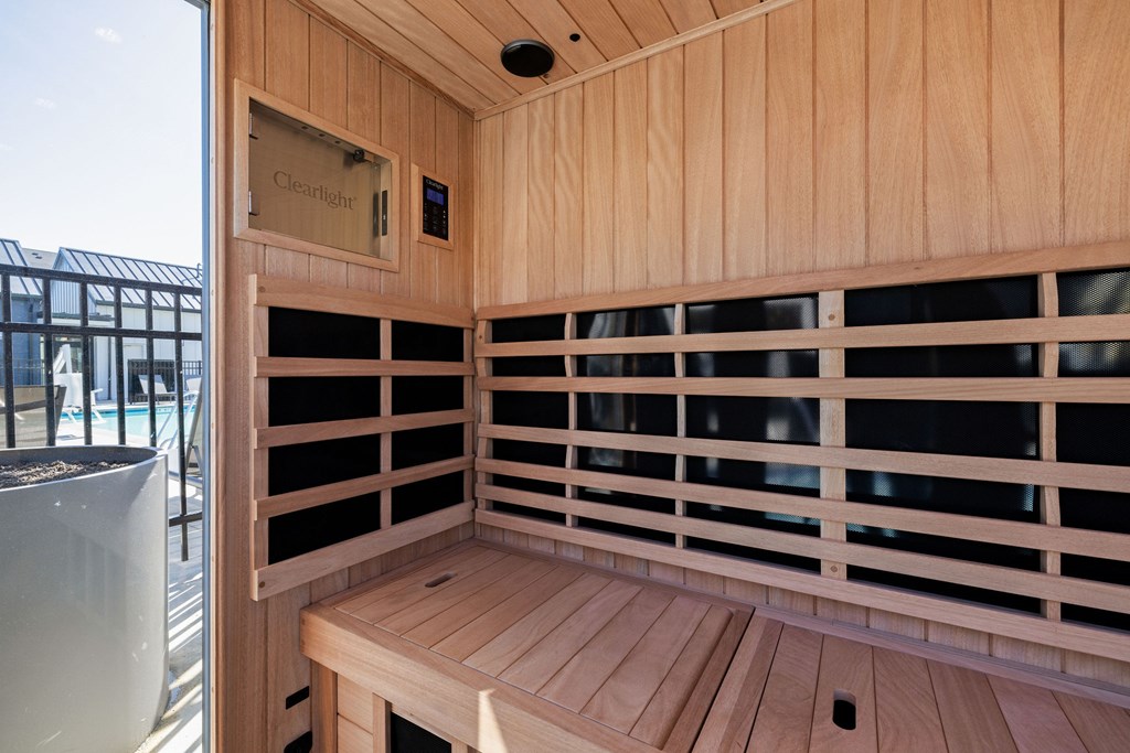 A wooden bench with a window above it and a sign that says "Cleverlich" on the wall.