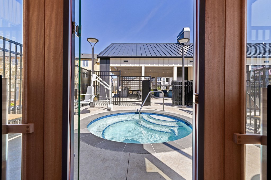 A small pool is seen through a glass door.
