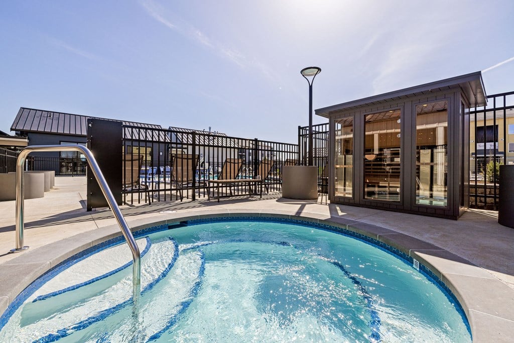 A small pool with a metal fence around it.