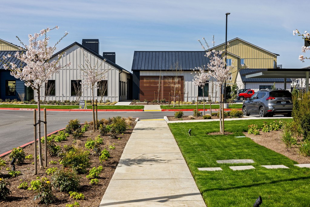 A building with a black roof and a white car parked in front.