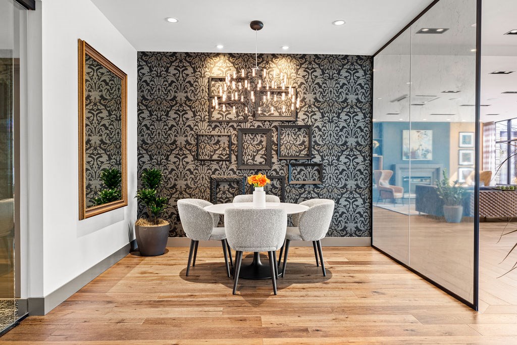 A dining room with a wooden table and chairs.