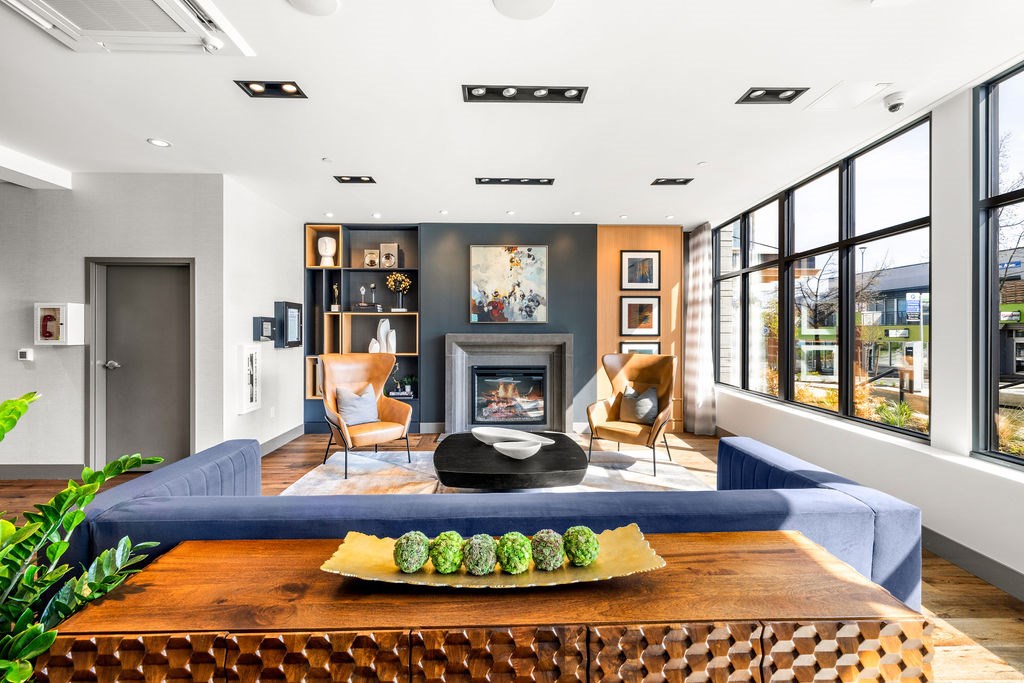A modern living room with a fireplace and a large window.