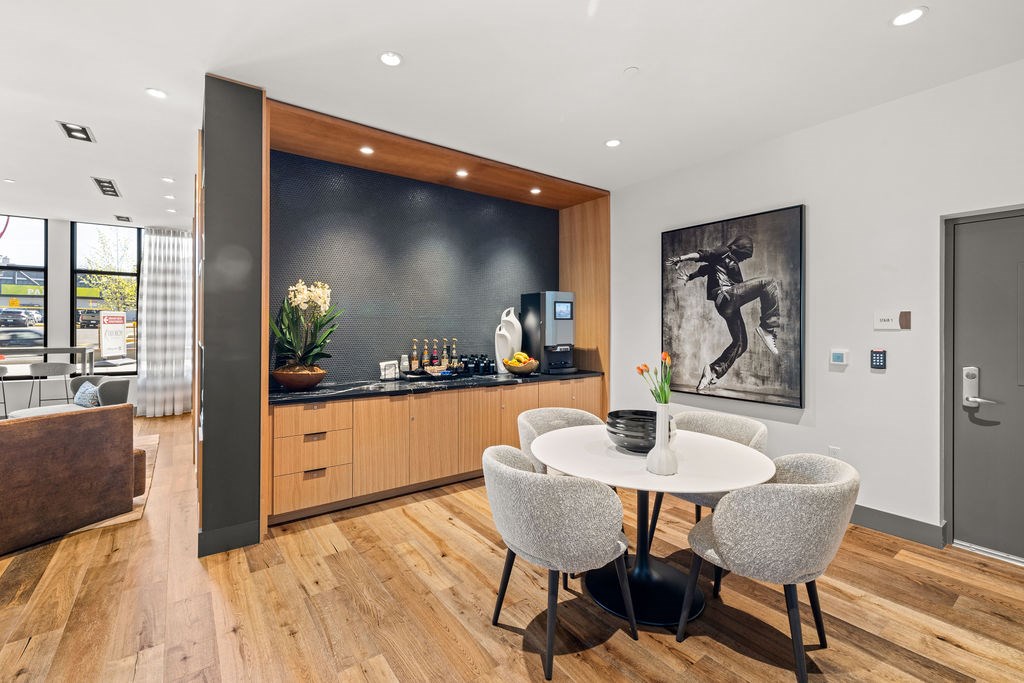 A modern kitchen with a dining table and chairs.