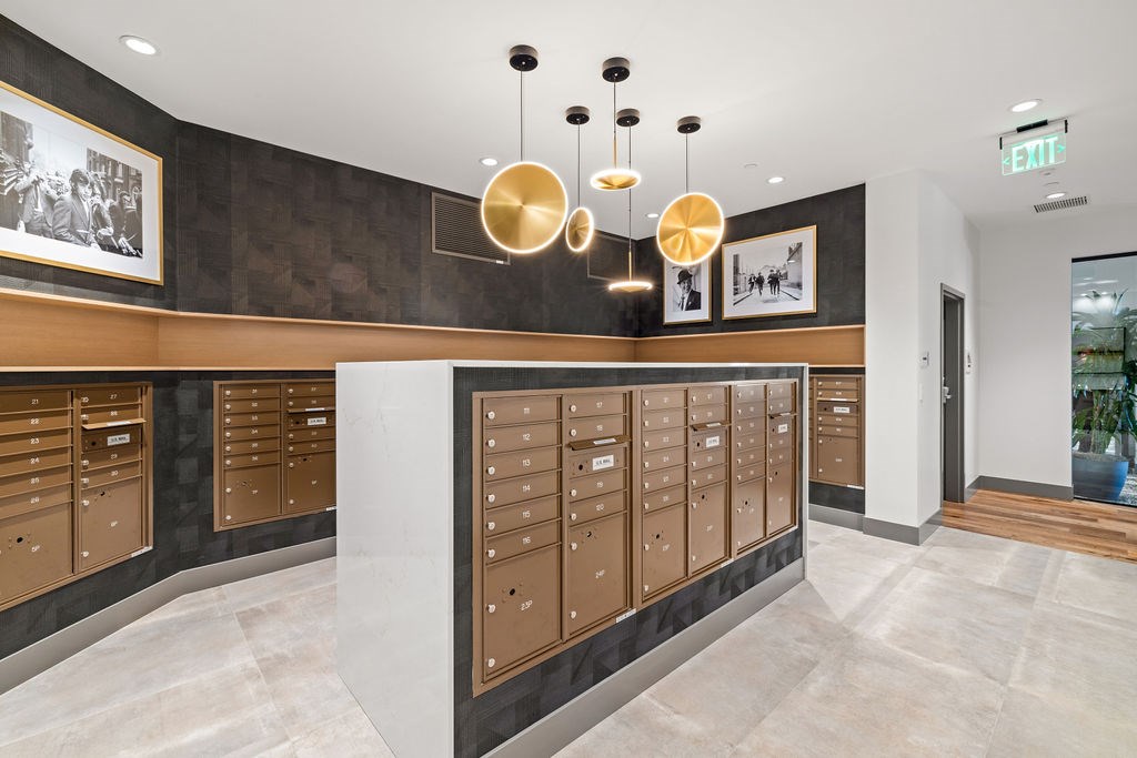 A row of brown mailboxes are lined up on a wall.