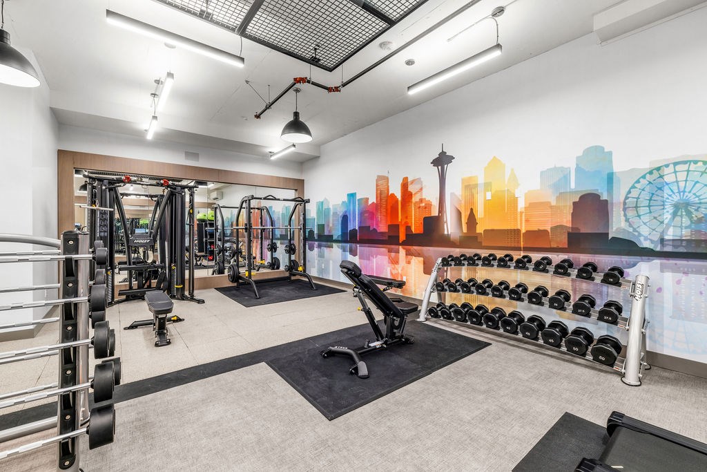 A gym with a city skyline mural on the wall.