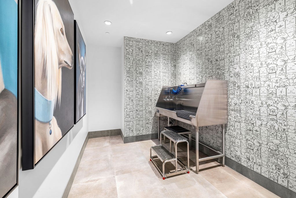 A room with a wallpapered wall and a painting of a horse on the wall.