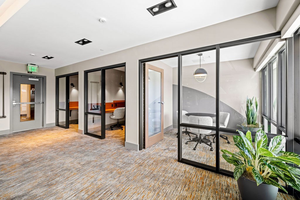 A room with glass walls and a carpeted floor.