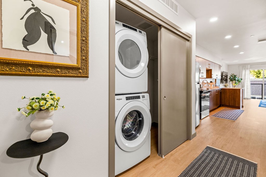 A modern laundry room with a washer and dryer built into the wall.
