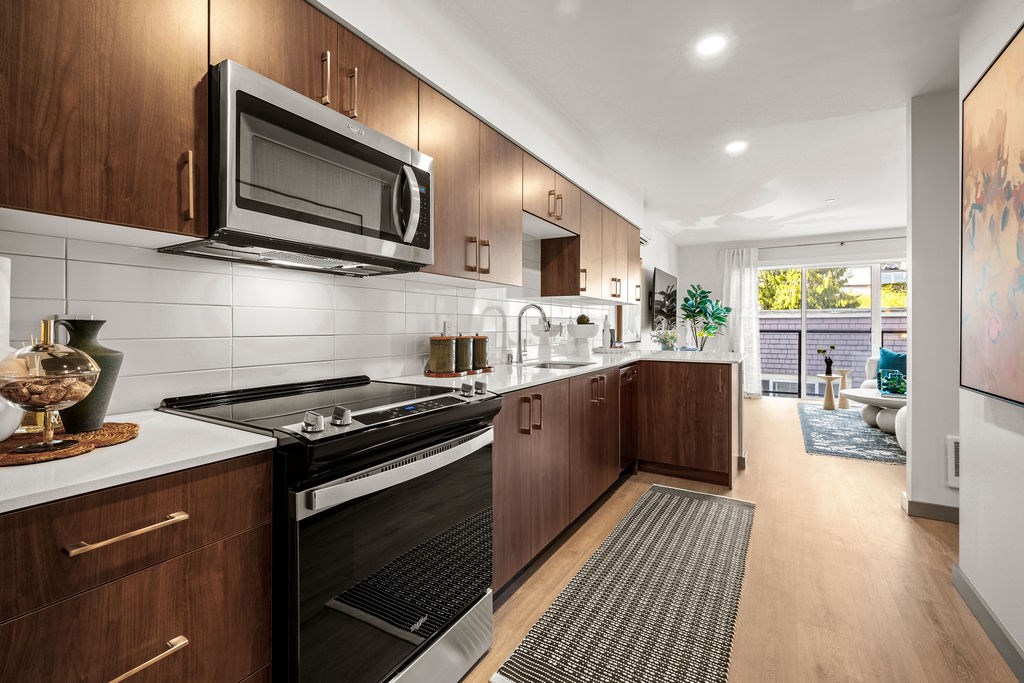 A modern kitchen with dark wood cabinets and a black stove top oven.