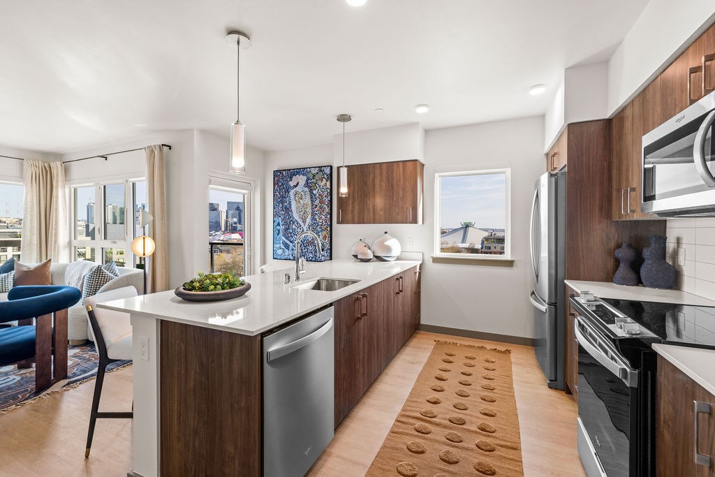 A modern kitchen with a large island and stainless steel appliances.