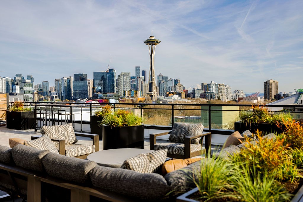 A rooftop patio with a view of the city skyline.