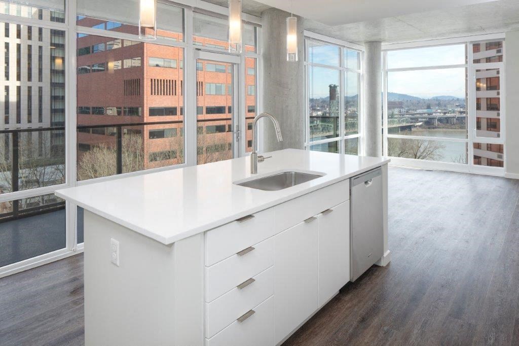 a kitchen with a sink and a large window