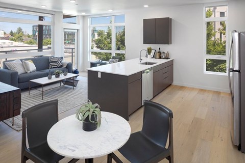 A modern kitchen with a table and chairs in the foreground.