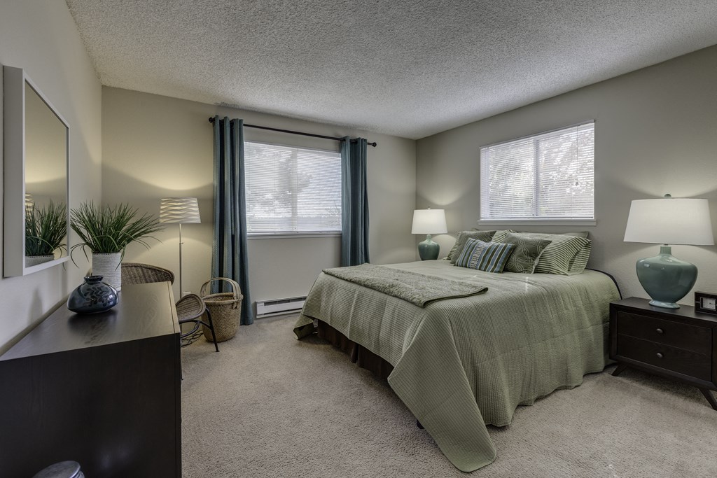 The Reserve at Bucklin Hill Apartments  bedroom with a bed and two windows