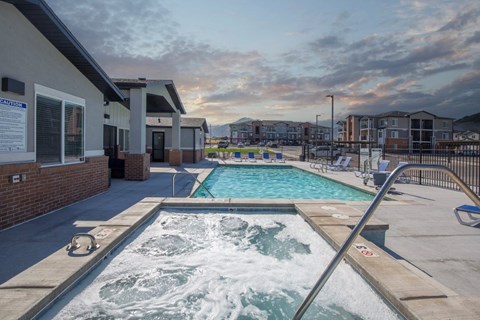 A hot tub sits in the middle of a patio area.