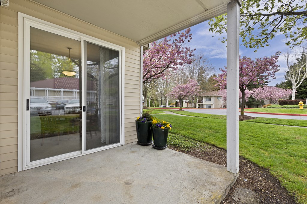 the view from the front porch of a home with a glass door