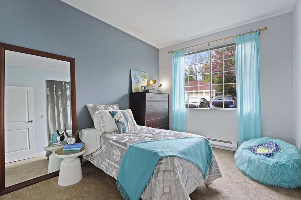 a bedroom with a bed and a mirror