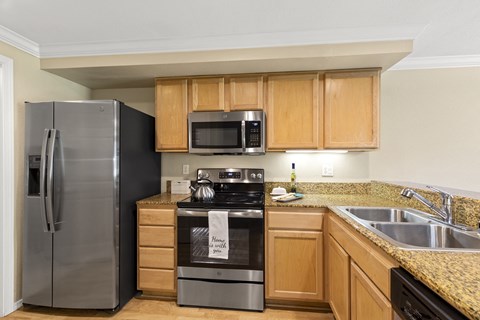 a kitchen with stainless steel appliances and wooden cabinets