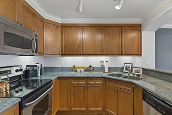 Villaggio on Yarrow Bay kitchen Villaggio on Yarrow Bay kitchen with dishwasher and wood cabinets - Photo Gallery 4